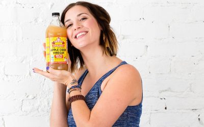 woman-with-a-bottle-of-apple-cider-vinegar-2-400x250.jpg